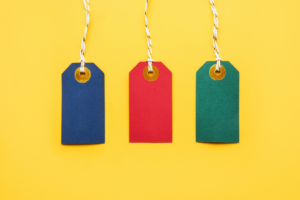 Colorful blank sale tags on yellow background. Black Friday and sales concept.