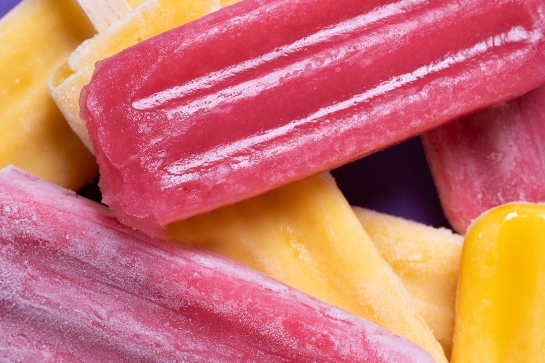 Variety of refreshing summer treats including ice cream, popsicles, fruit snacks, and cold drinks for wholesale customers
