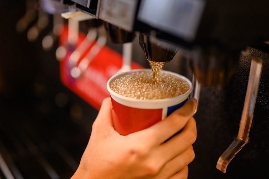man pours a fizzy drink.sparkling water cool ice soft drink cola